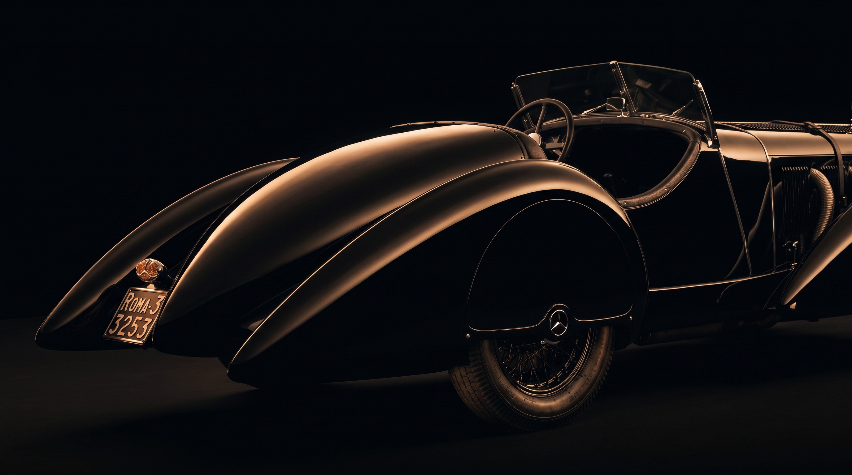 Rear view of the Count Trossi SSK's black boattail and teardrop fender under studio light