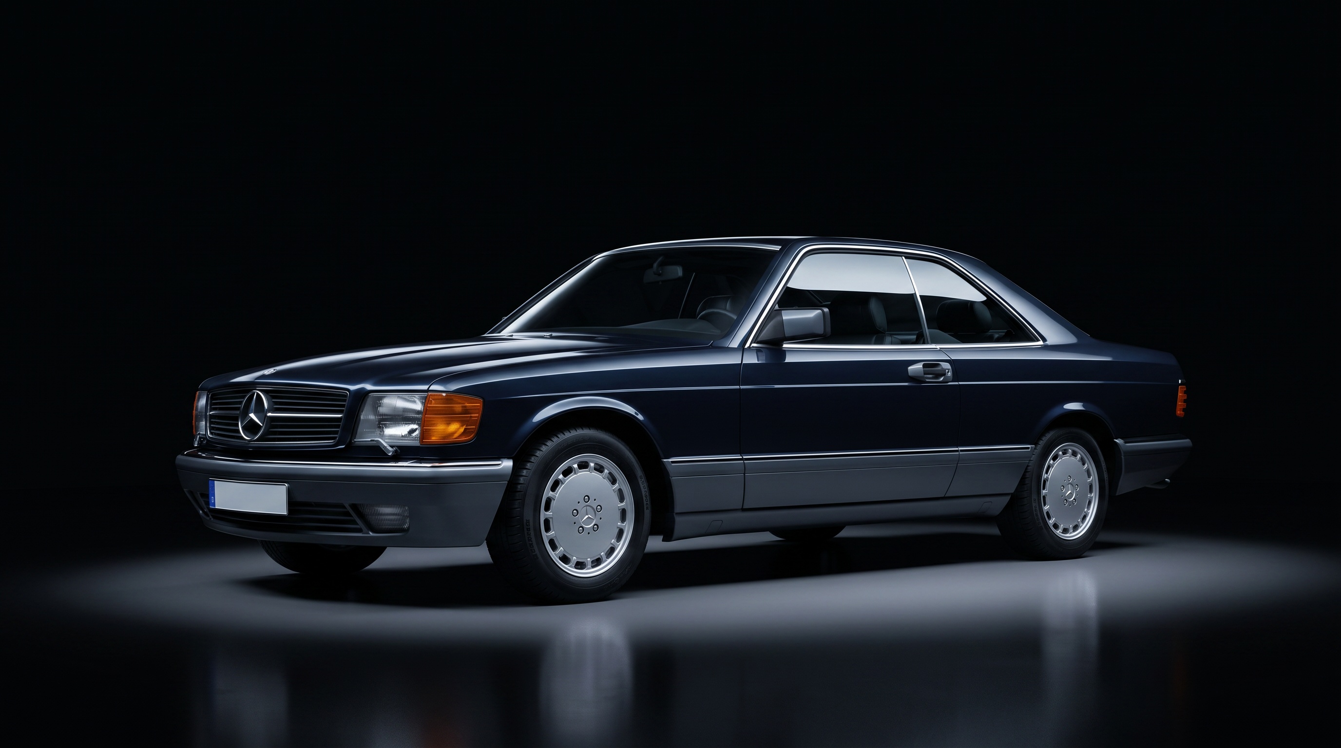 A dark blue Mercedes-Benz 560 SEC coupé in studio darkness